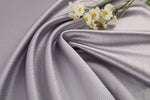 Polka dot embossed satin fabric, 185 g/m² woven polyester, suitable for elegant women's clothing.