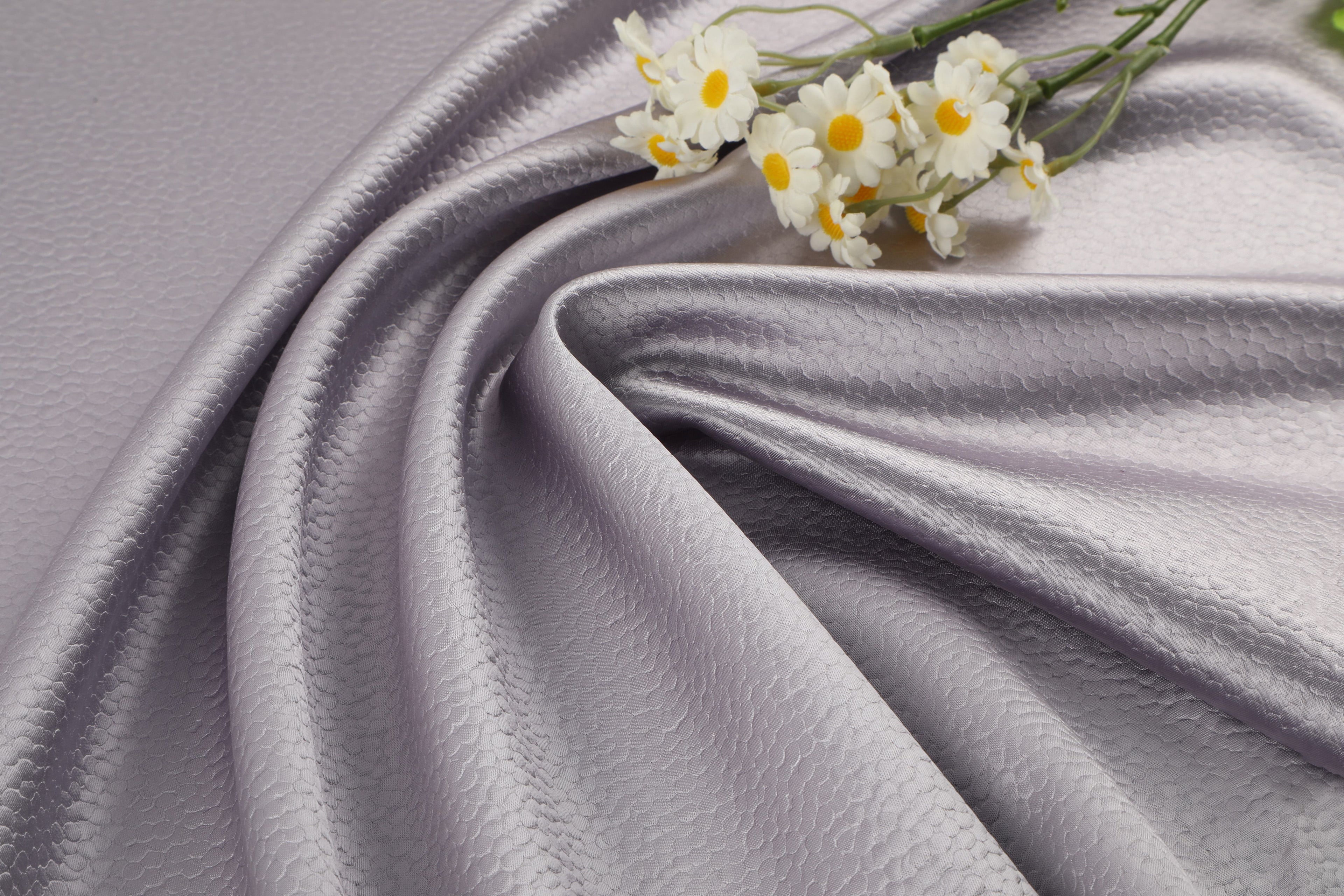 Polka dot embossed satin fabric, 185 g/m² woven polyester, suitable for elegant women's clothing.