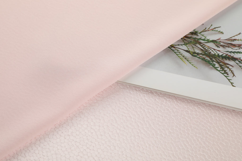 Polka dot embossed satin fabric, 185 g/m² woven polyester, suitable for elegant women's clothing.