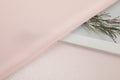 Polka dot embossed satin fabric, 185 g/m² woven polyester, suitable for elegant women's clothing.